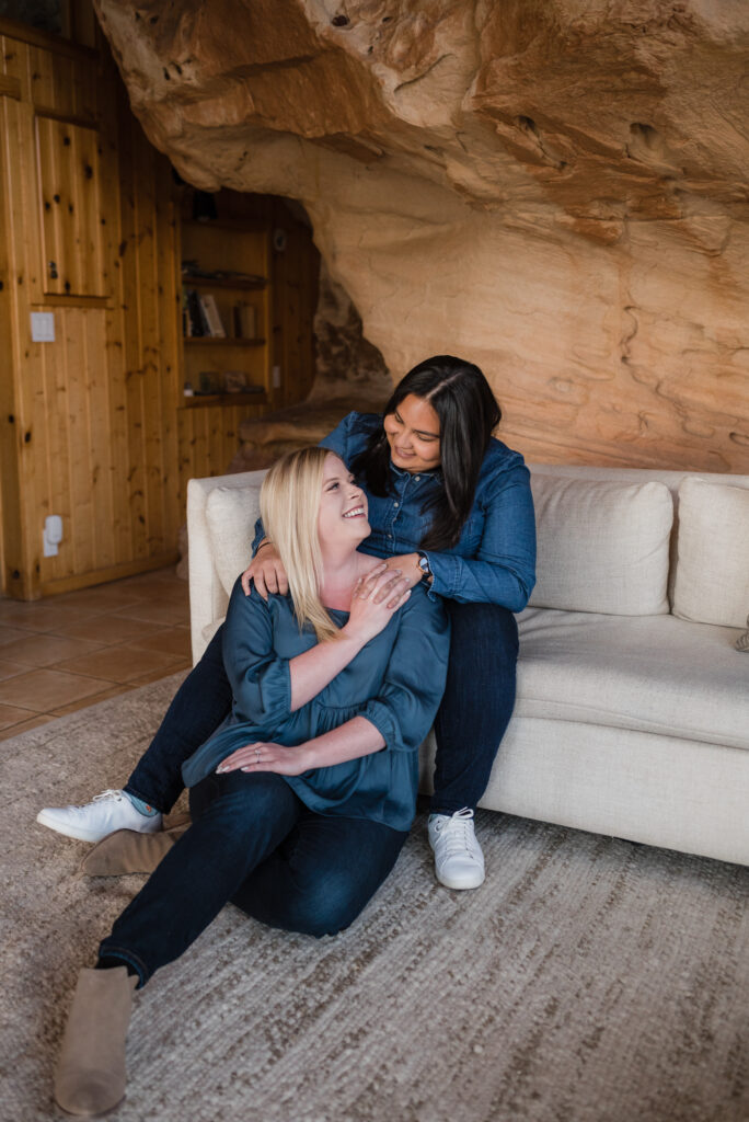 couple posing inside for their cozy engagement photos