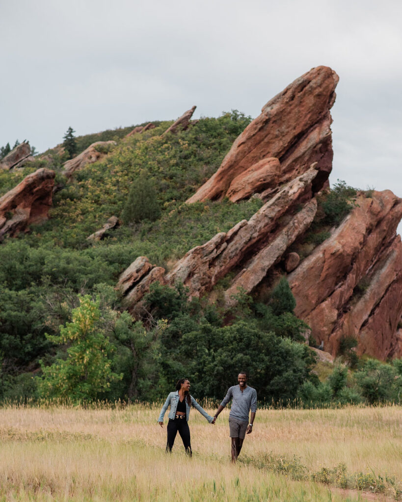 couple posing on the mountains in colorado for their engagement photos