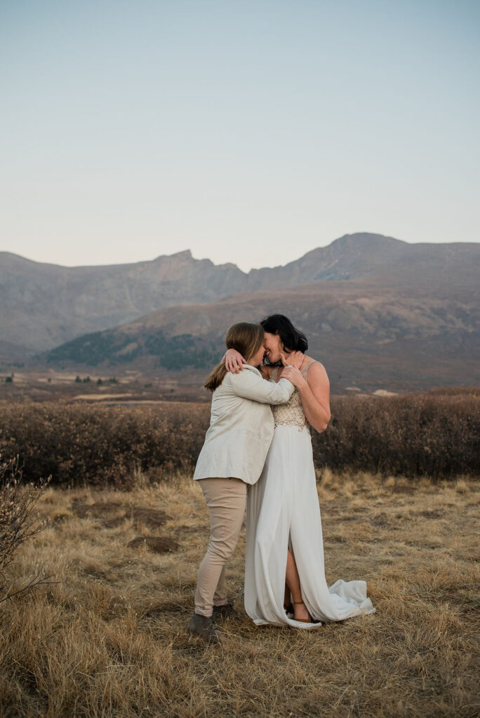 couple posing during their engagement photos in colorado mountains