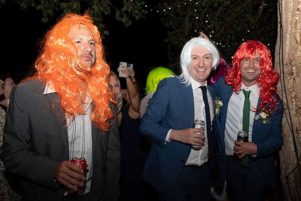 guests at reception wearing fun wigs