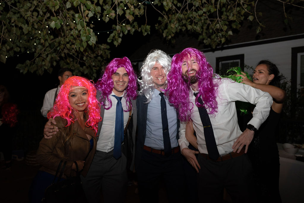 guests at reception wearing fun wigs