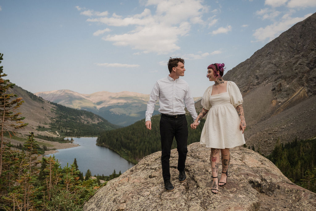 couple holding hands in the mountains posing for their elopement photos